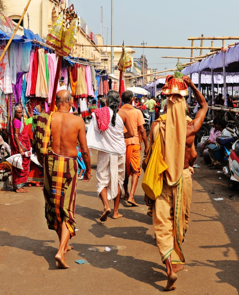 Men in traditional lungis and dhotis outside Jagannath Mandir, Puri